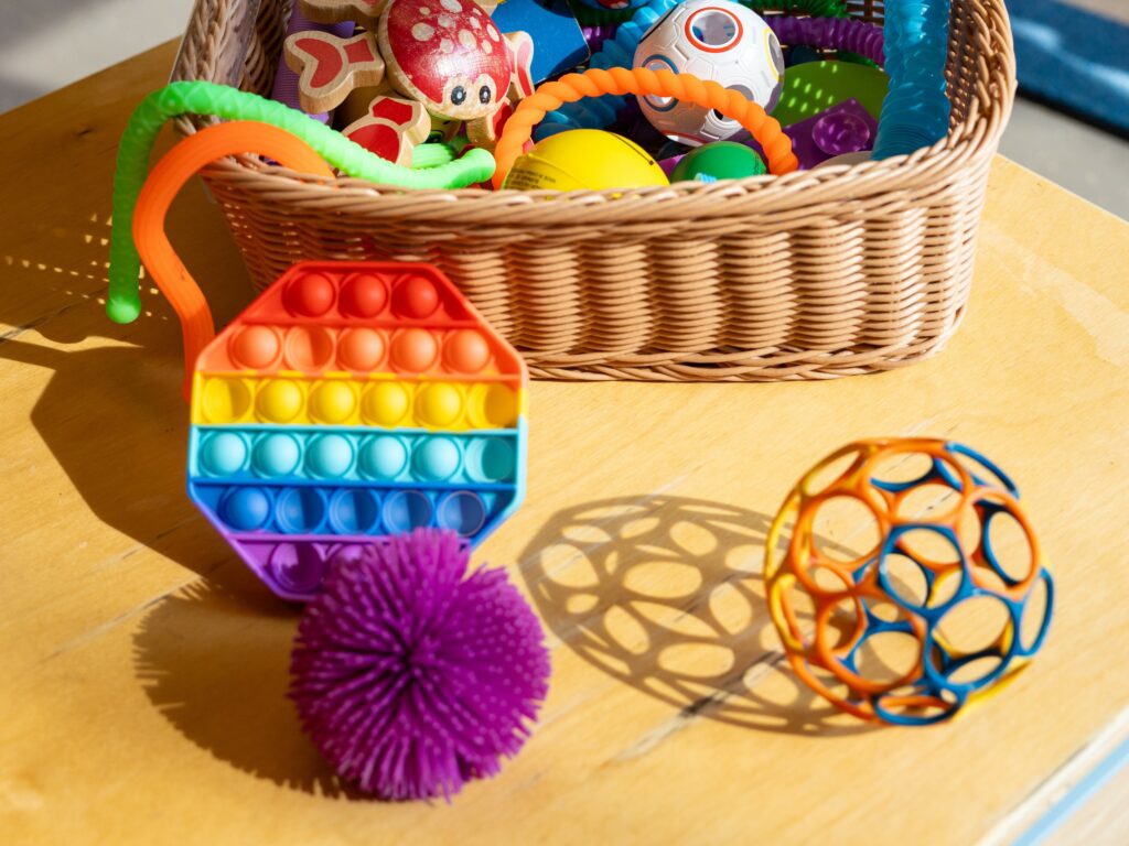 sensory tool kit full of sensory fidget toys such as pop-its and pop tubes