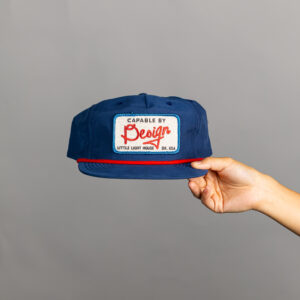 Blue hat with red rope and patch with slogan