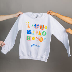 White sweatshirt that says Little Light House in a colorful design